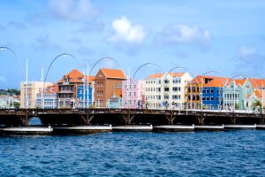 Floating bridge in Curaçao. with colorful buildings on the shoreline.