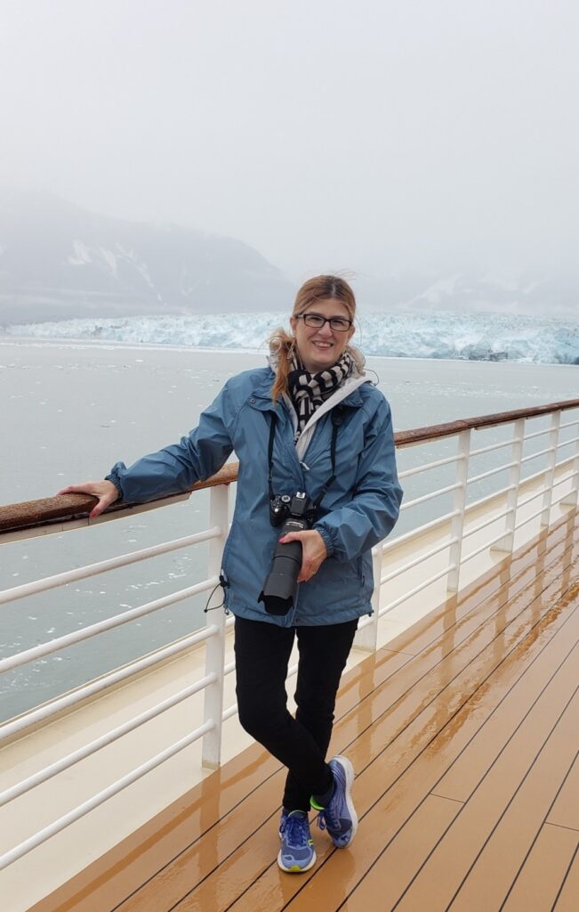 Kathleen Penner 
Luxury Cruise Travel Agent Travel Advisor standing at Hubbard Glacier